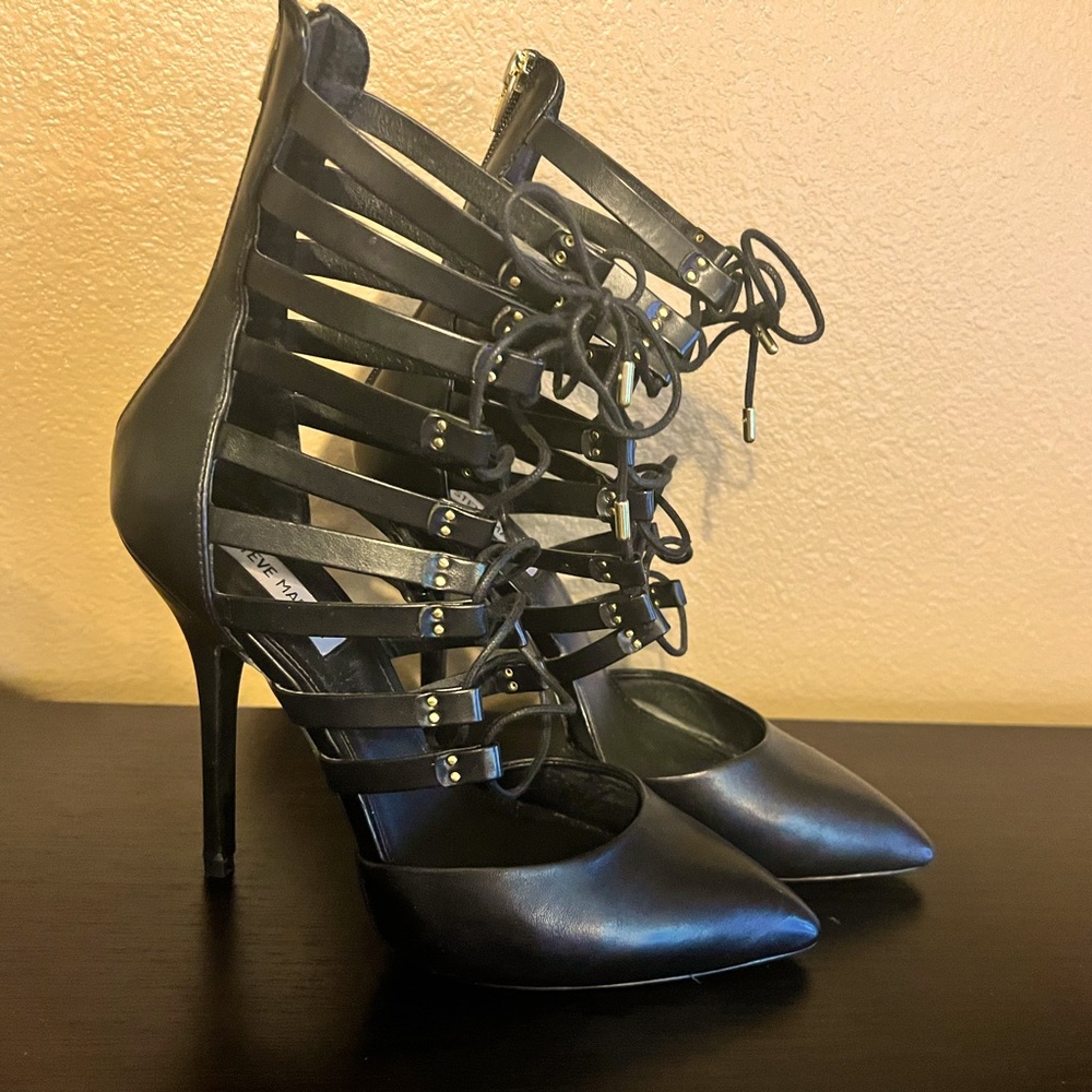 Steve Madden black leather pump. Ties up the front and zips up the back.